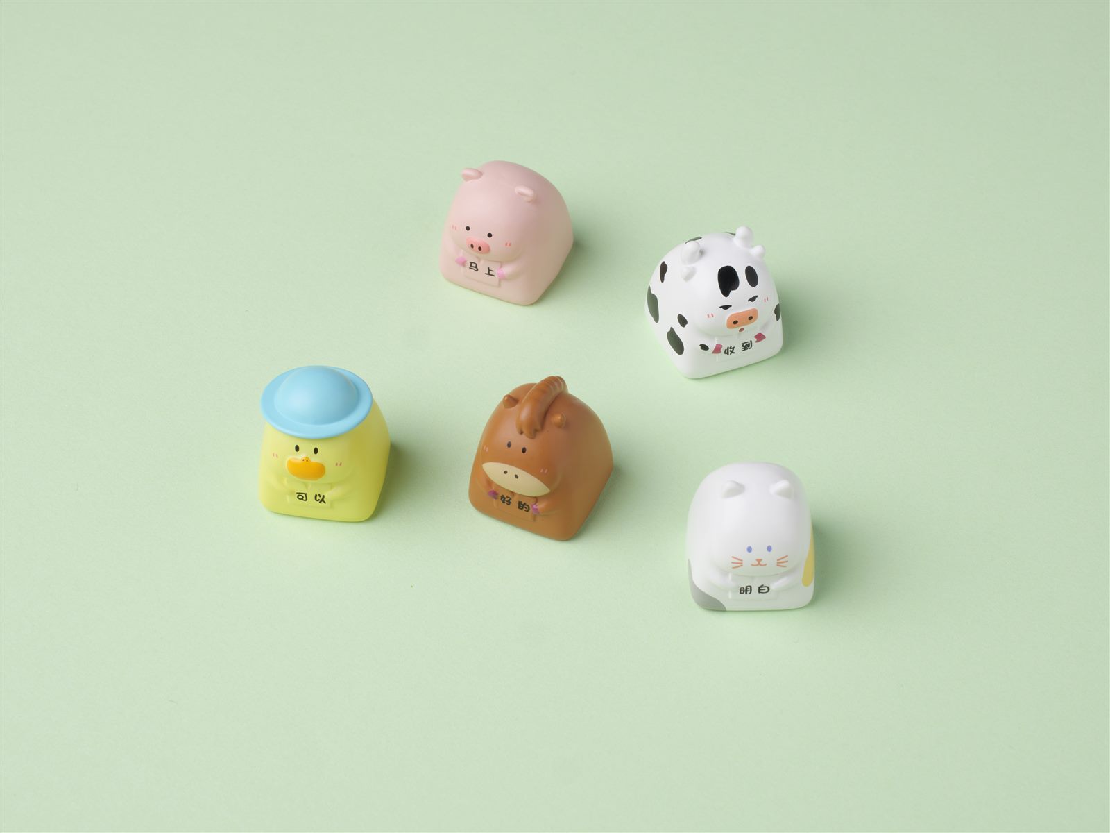 Five character resin keycaps arranged as a blind box collection