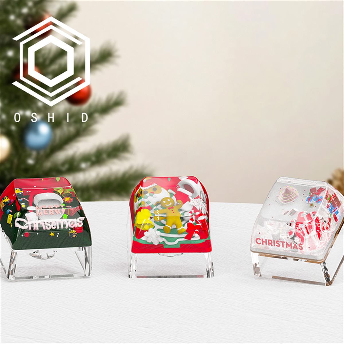 Three transparent resin artisan keycaps containing different miniature holiday scenes