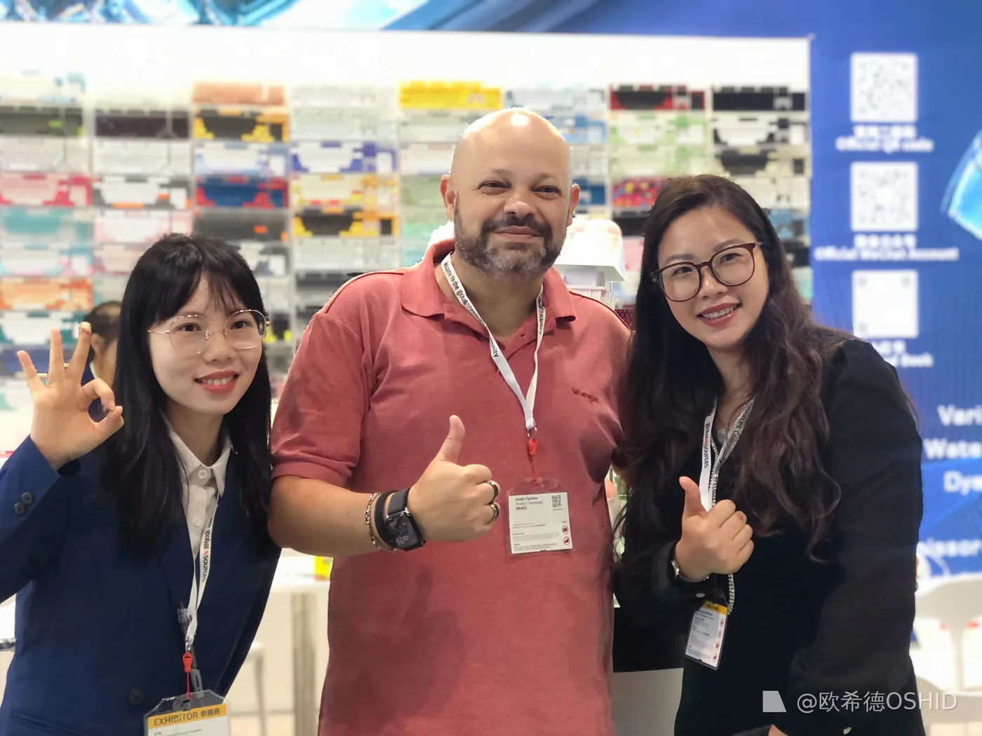 OSHID team with a customer at a keyboard trade show
