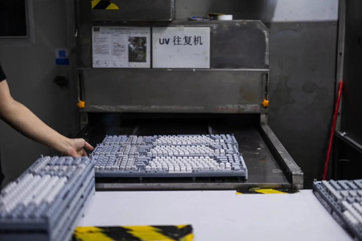 OSHID worker inspecting packaged custom keycap sets
