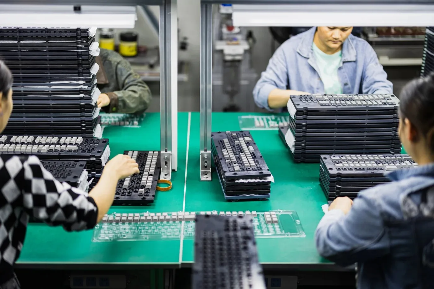 OSHID staff reviewing custom keycap samples on the production line